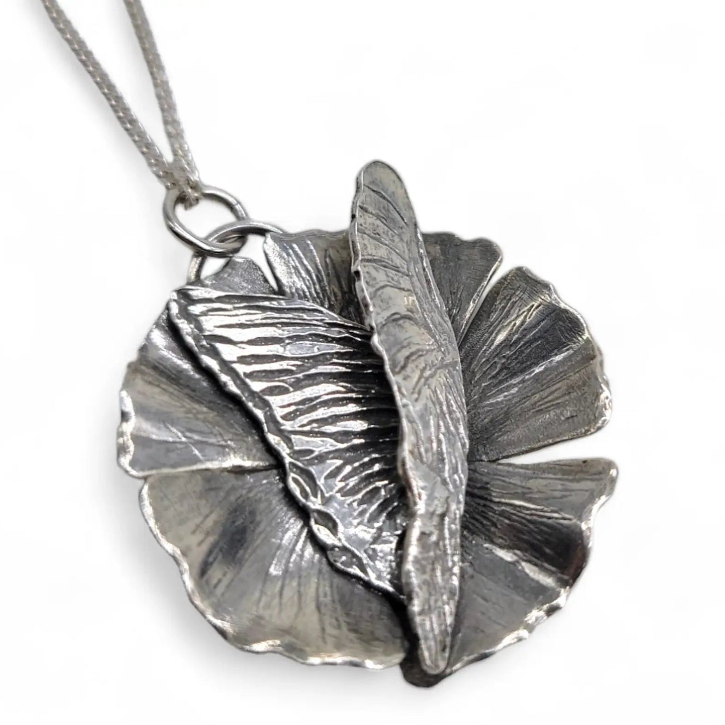 Handmade Silver Custom Necklace of Butterfly on a flower by Jaclyn Nicole.