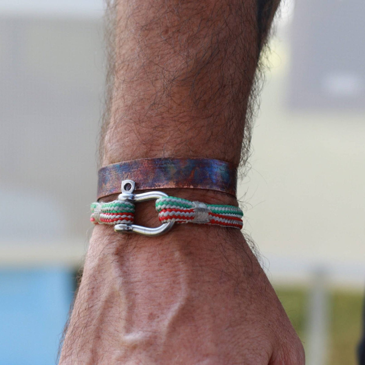 flame painted copper cuff bracelets modeled on man's wrist