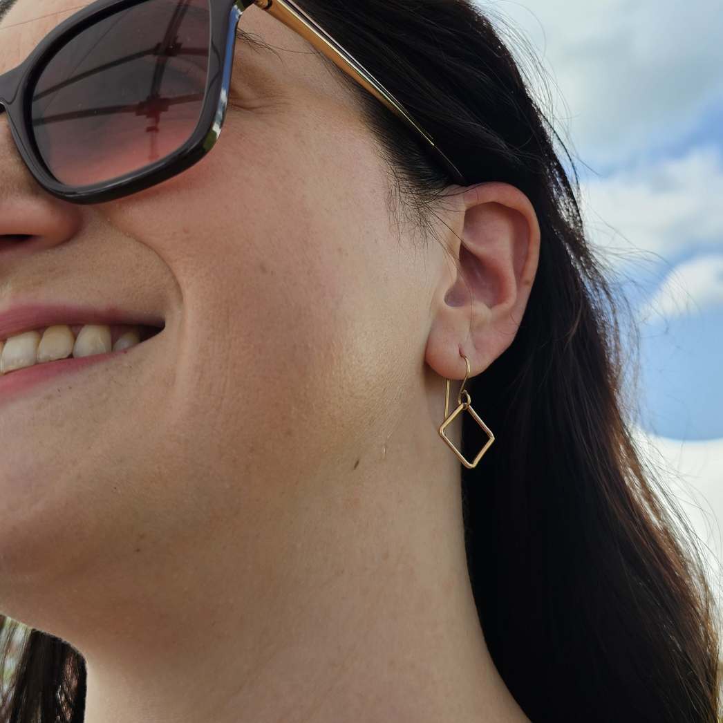 Smiling woman wearing Gold Square Drop Earrings Drops