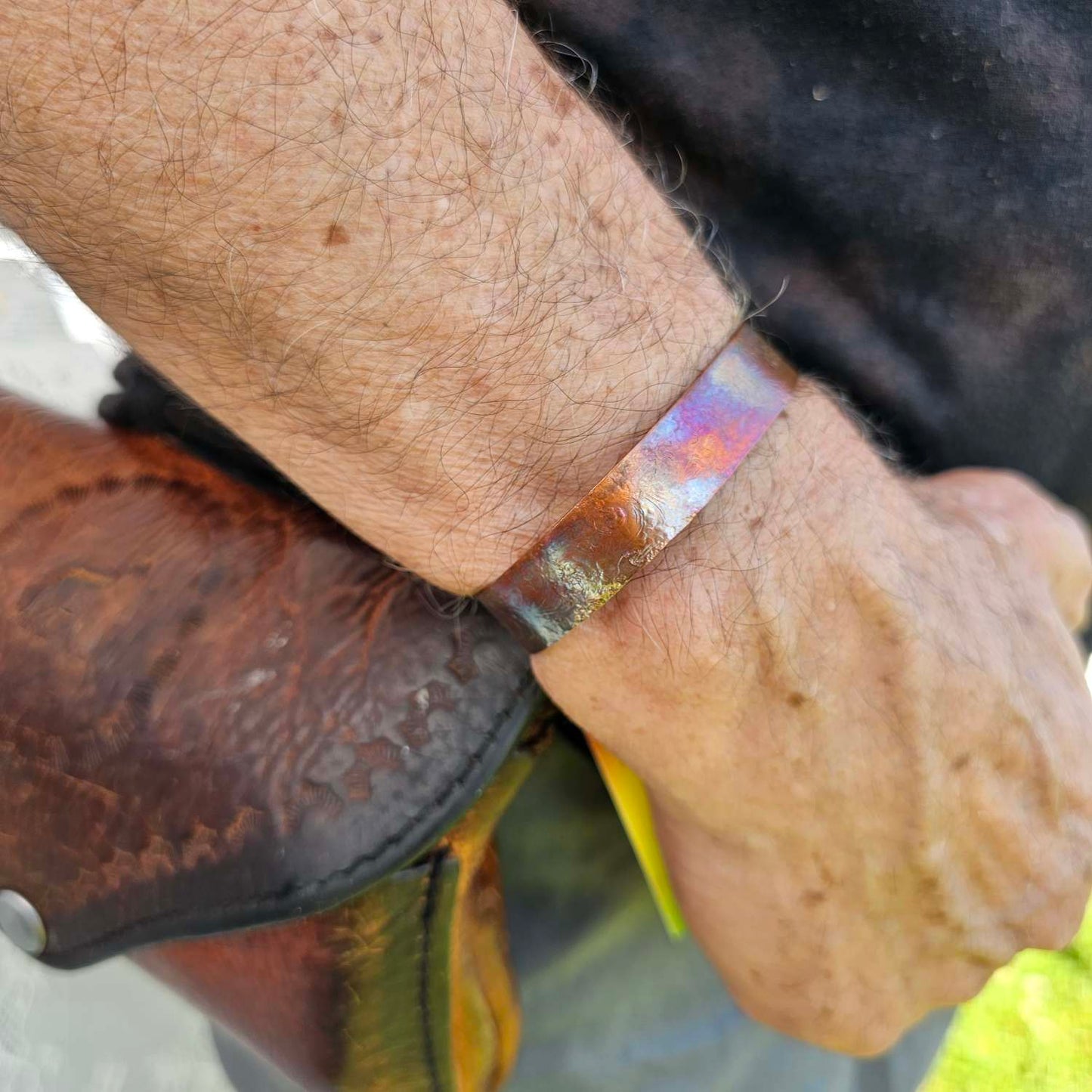 Flame Painted Copper Bracelet on man's wrist by Jaclyn Nicole