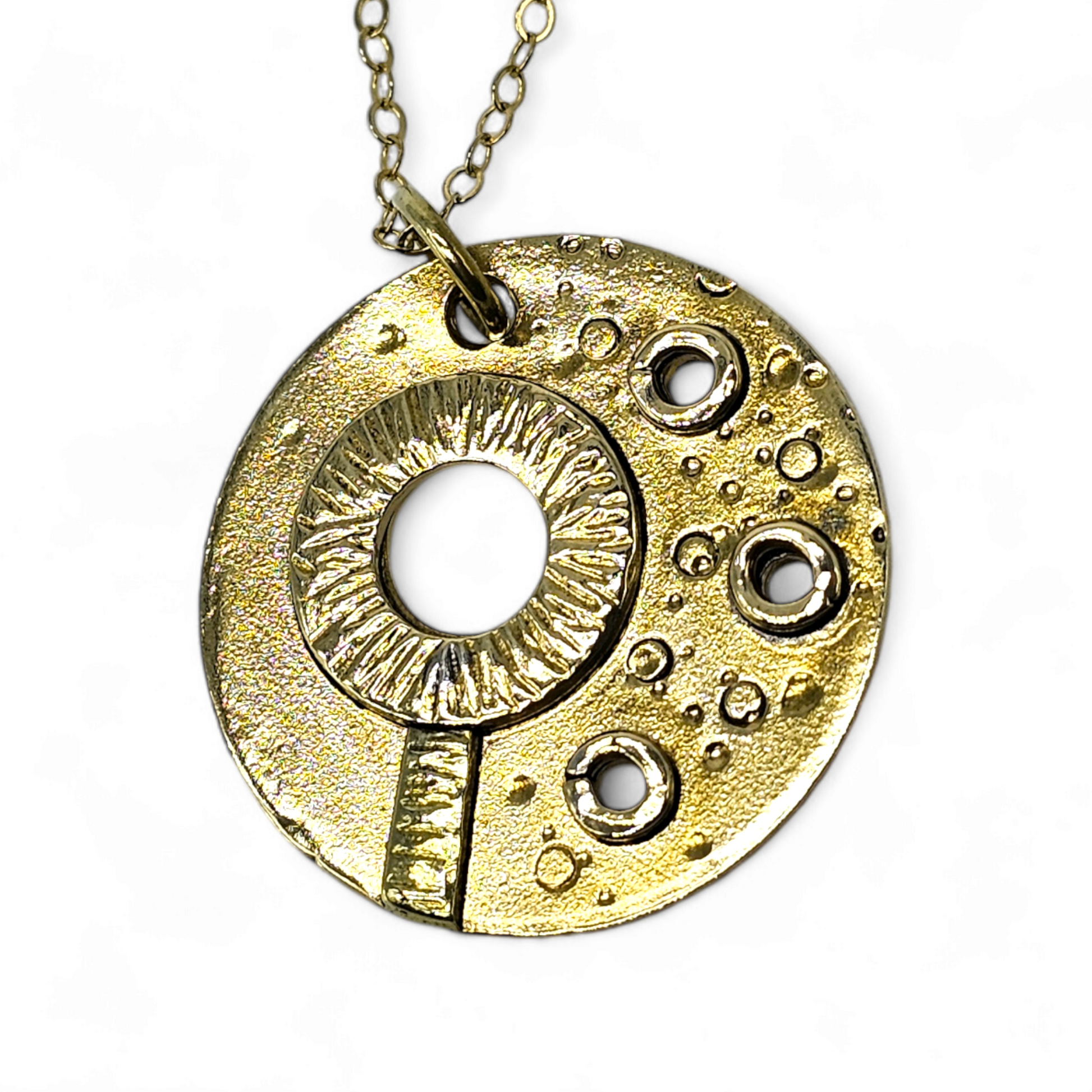 Gold textured circle pendant that forms an image of a bubble wand and bubbles.