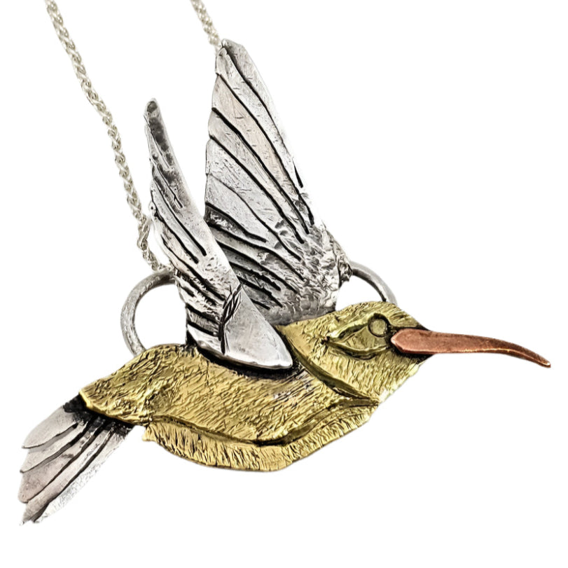 close up of handmade hummingbird pendant necklace on white background