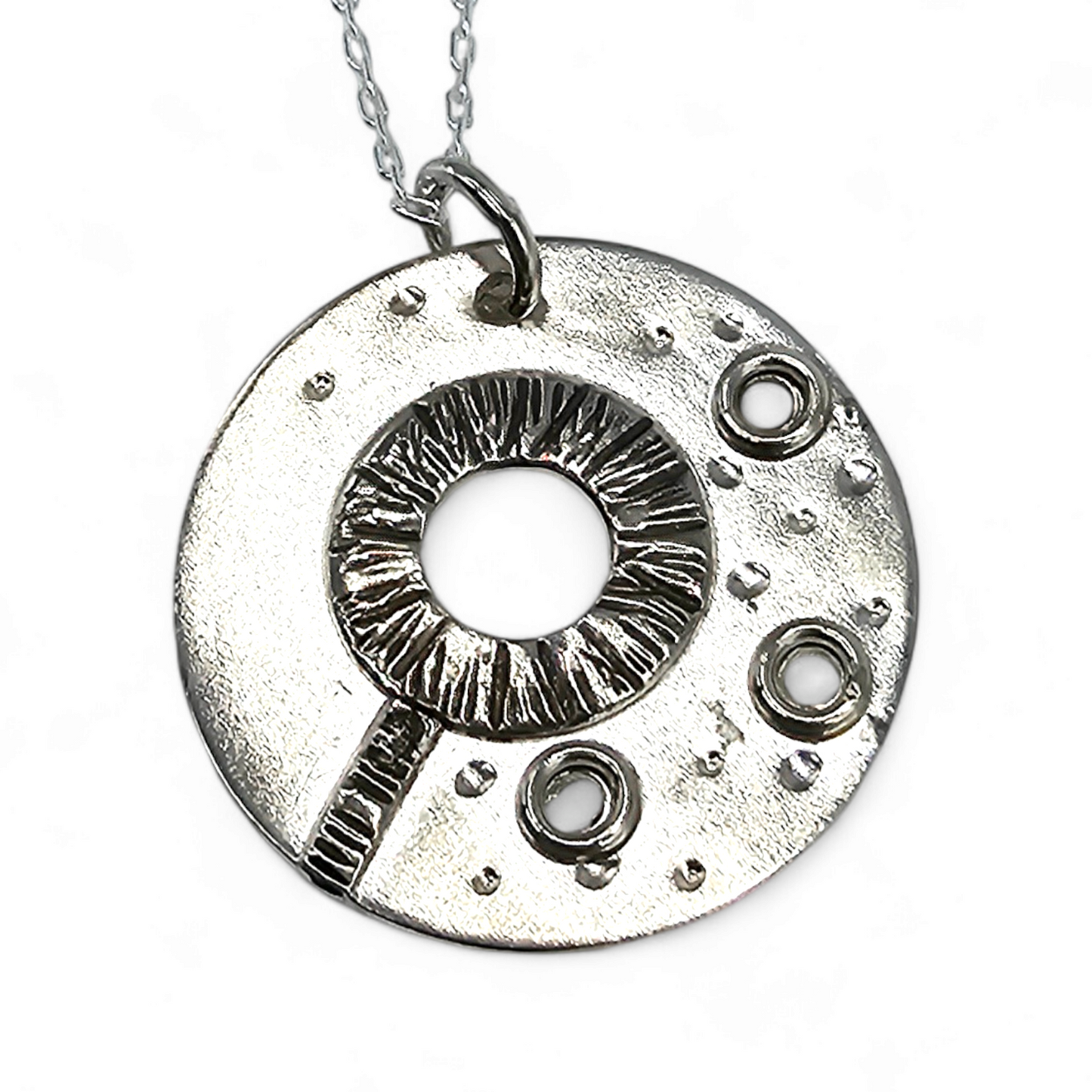 Silver textured circle pendant that forms an image of a bubble wand and bubbles.