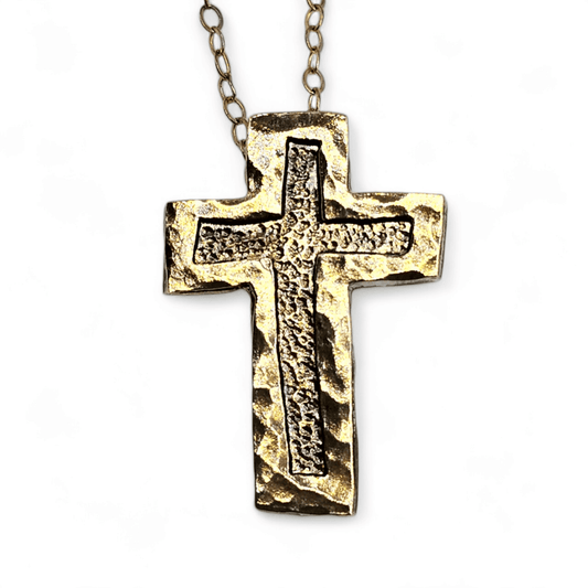 Gold Christian cross necklace on a chain with hammered border and dot textured base.