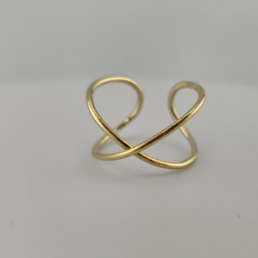 14K yellow gold infinity ring on grey background.