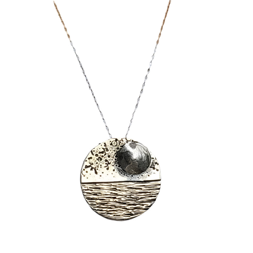 Reflections domed moonlit seascape necklace on white background.