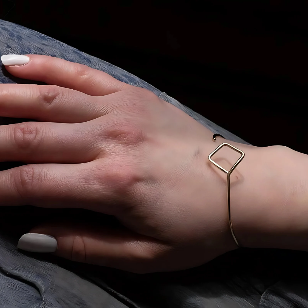 Gold Cuff Bracelet with Square worn on woman's wrist.