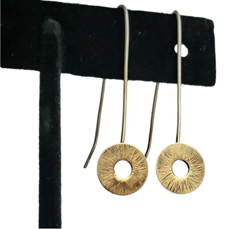 Gold Circle drop earrings on a black earring stand.