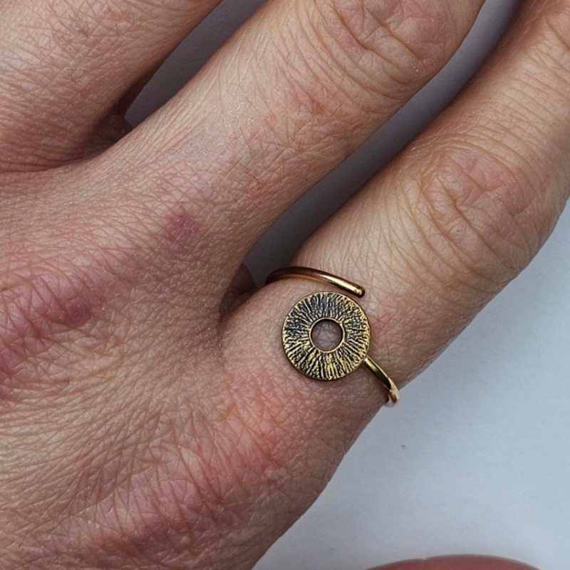 Gold Circle adjustable ring on woman's finger 