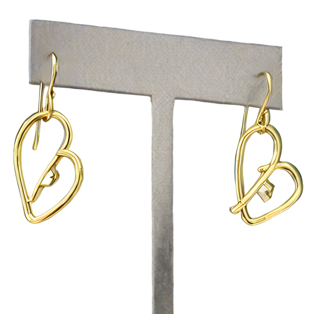 Close up of Self love key heart shaped drop earrings in 14k gold