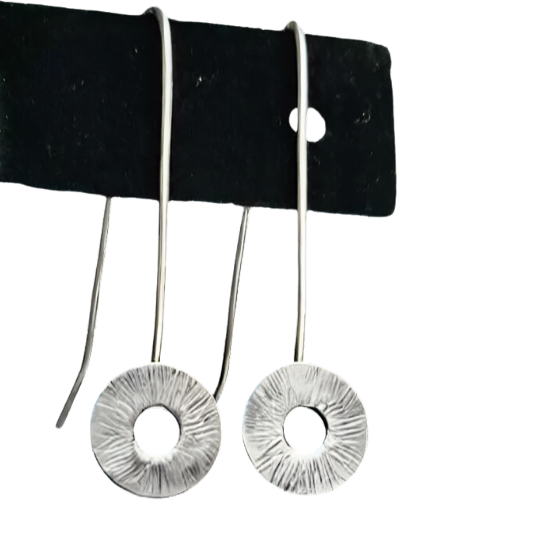 Close up of silver Circle drop earrings on a black earring stand.