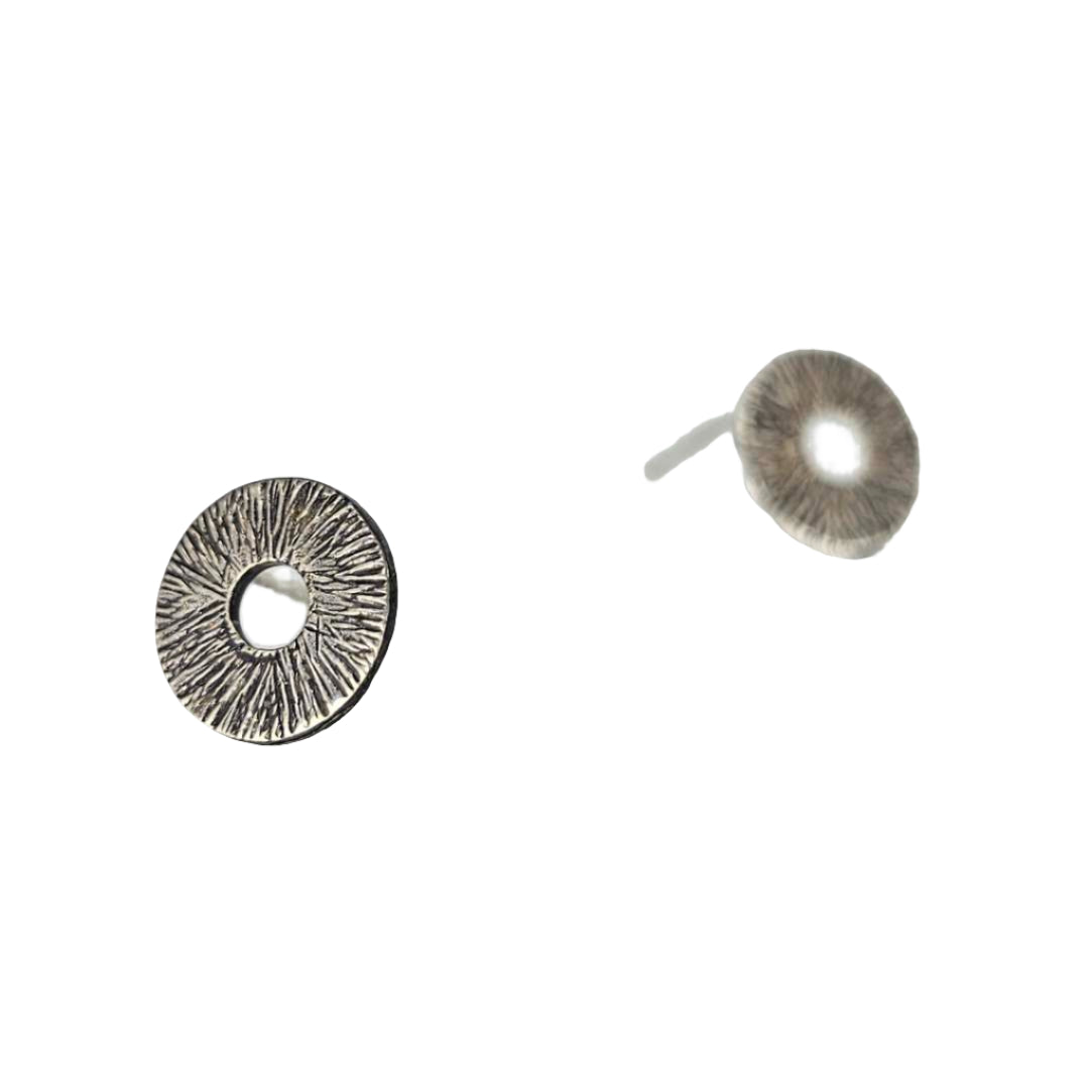 Silver Stud Circle earrings in front of a white background.