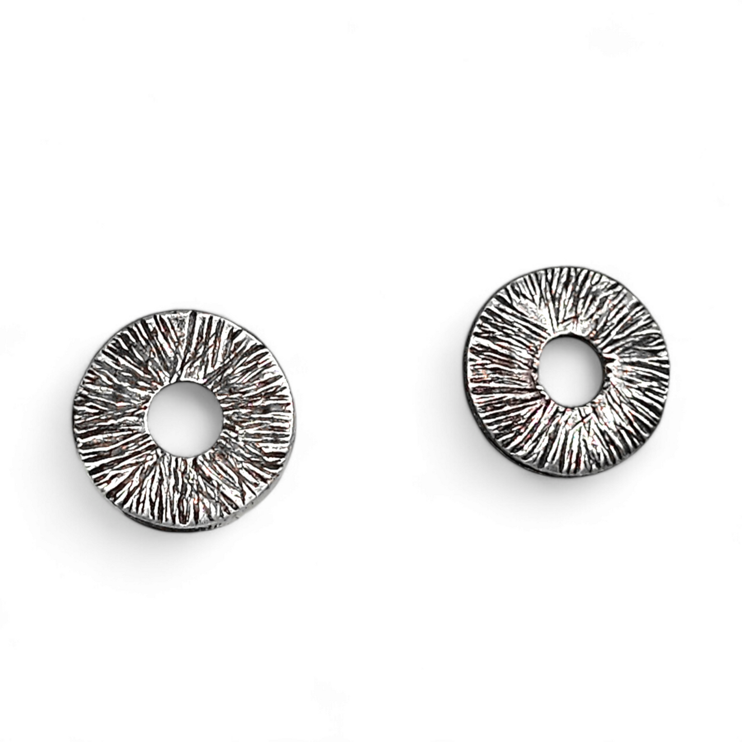 Silver manifestation earrings on a white background.