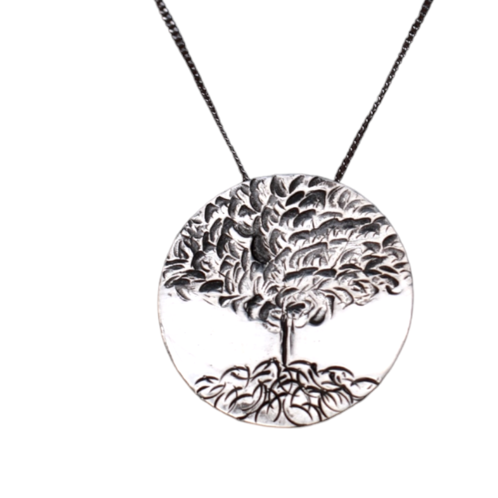 Handcrafted Tree of Life pendant necklace in sterling silver on white background.