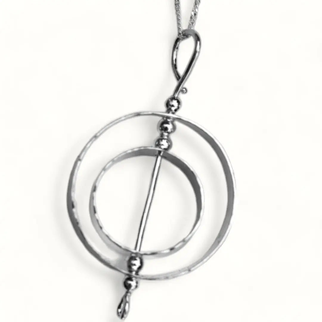 Silver Fidget jewelry karma necklace on a white background.