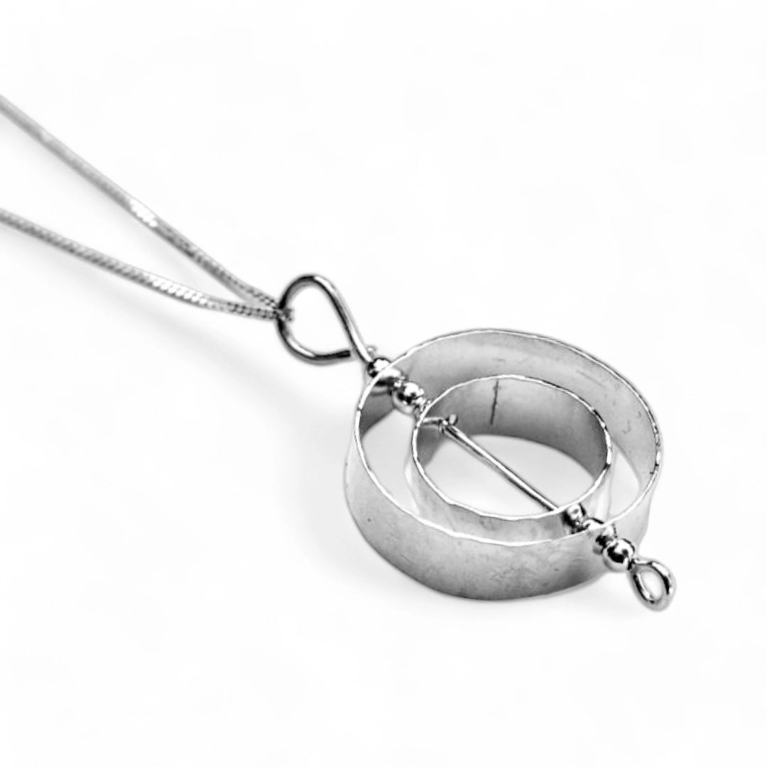 Sterling silver fidget jewelry for adults necklace on a white background.