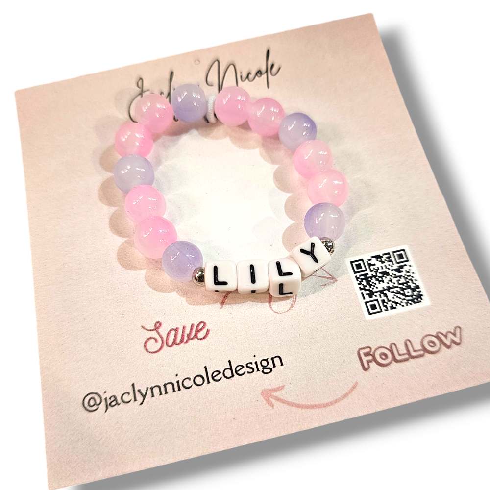 Pink and purple personalized bead bracelet with the name Lily on it.