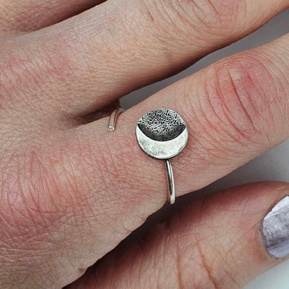 Silver Stars and Moon adjustable ring on woman's pointer finger.