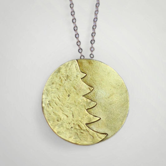 A gold christmas tree pendant necklace.