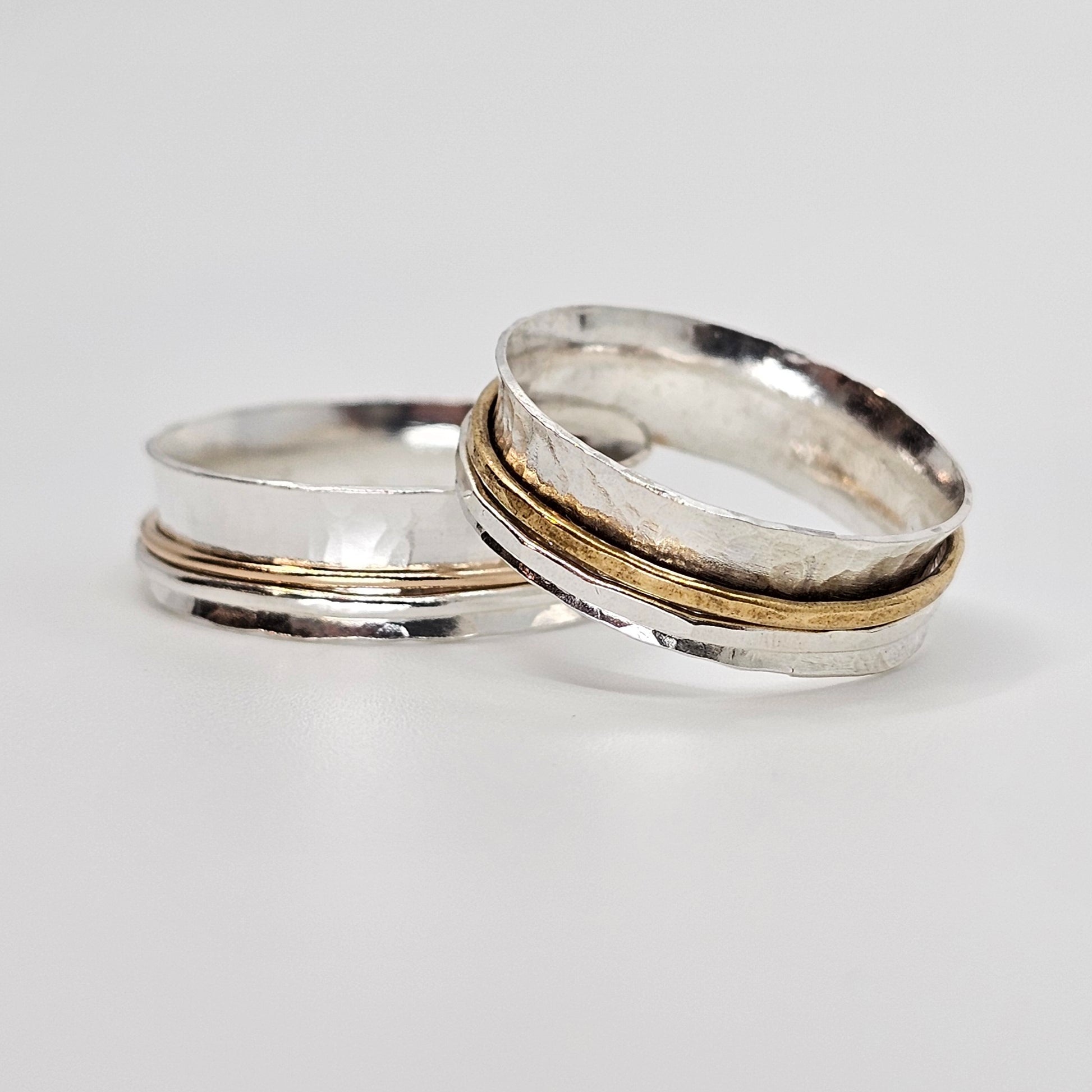 2 silver spinner anxiety rings each with 1 silver and 1 gold movable ring around the center