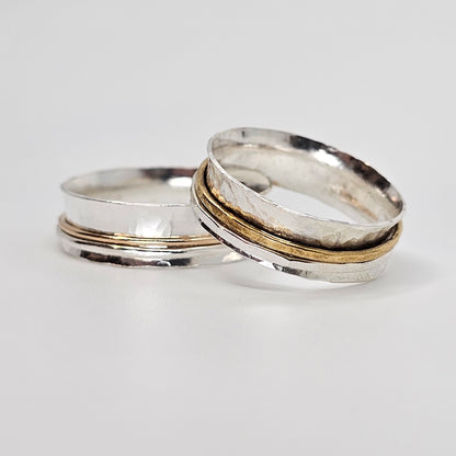 2 silver spinner anxiety rings each with 1 silver and 1 gold movable ring around the center