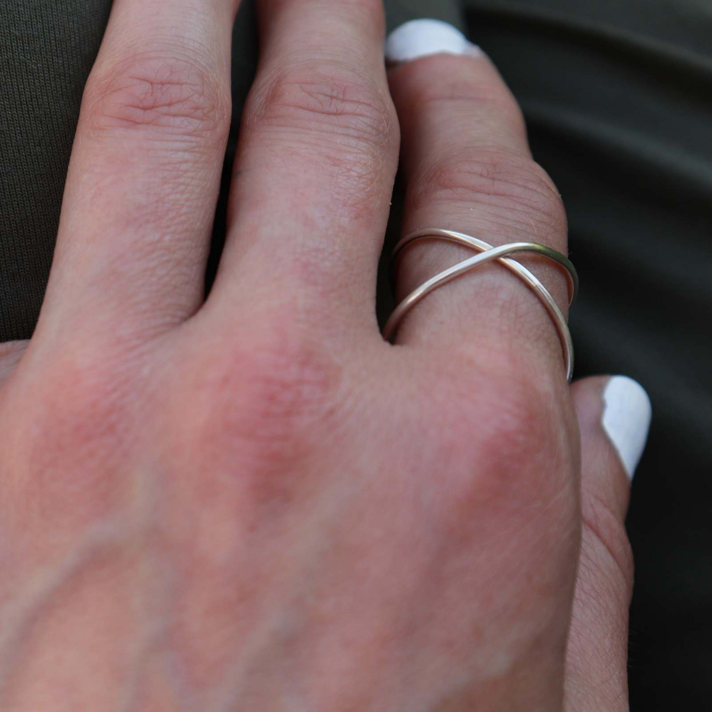 Silver adjustable Infinity Ring modeled on woman's pointer finger