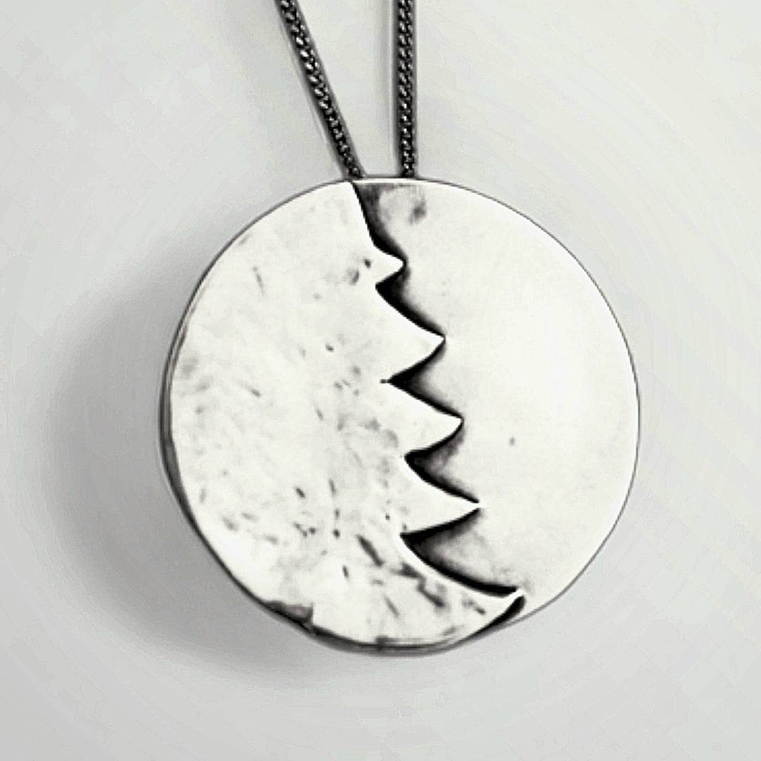 A silver Christmas tree pendant necklace.